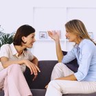 Two women on the couch looking annoyed with one another.