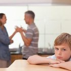 Mature man watches mother and daughter in kitchen