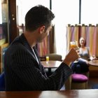 Young couple sitting on sofa holding champagne flutes