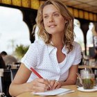 Woman writing note on coffee table