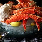 Crab legs on a serving platter with butter and lemon wedges