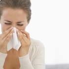 Young woman removing makeup with cleansing pad