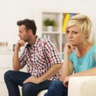 Unhappy friends not talking after argument on the couch
