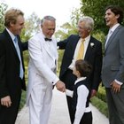 Adults wearing formal attire, toasting champagne glasses