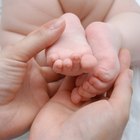 friendly  children's doctor examining newborn