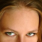 Woman checking appearance in bathroom mirror