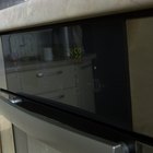 Woman removing cookies from oven