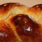 Homemade bread with spikelet of wheat on cloth on boards