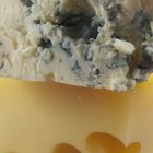 Quarter of Emmental cheese head on the market place. Close-up