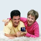 Man giving woman present at picnic in park