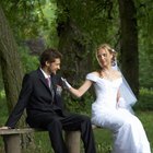 People Throwing Confetti Over a Newlywed Couple Leaving Church