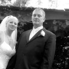 Bride and groom walking under arms of wedding guests