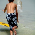 Rear view of multi-ethnic surfers