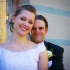 portrait of the bride and groom standing with a bouquet of flowers