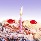 portrait of an elderly man holding up a present for a birthday celebration