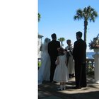 portrait of the bride and groom standing with a bouquet of flowers