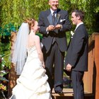 Groom putting a ring on bride's finger