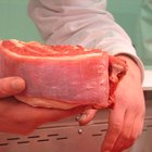 Raw pork chop steak on wooden background