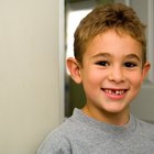 Boy holding missing teeth