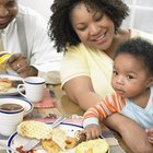 African girl in front of vegetable dish.