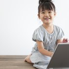 Young man and his son using a laptop