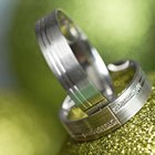 Jeweler assisting couple with rings