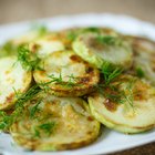 Garlic bulb in plate with eggplant, directly above