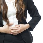 Hispanic girl hugging pregnant mother