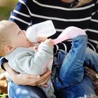 Charming mother feeding her adorable son in the kitchen