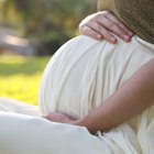 Close up of pregnant African woman's hand on bare belly