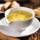 Egg drop soup in a bowl garnished with green onion