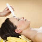 Picture of pretty beautician doing microdermabrasion procedure.