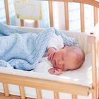 Portrait of a peaceful baby sleeping in his cradle at home