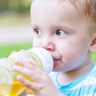 Child with allergic reaction eating big green lollipop