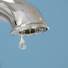 Stainless steel sink plug hole close up with water