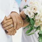 Bride and groom kissing in park, close-up