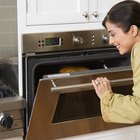 Woman removing cookies from oven