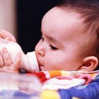 Hispanic baby drinking from bottle