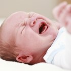 Crying baby comforted by woman