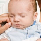 five-months baby closes mouth with hand