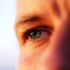 A headshot of a teen Caucasian female using a cleansing pad on her face while looking at the viewer