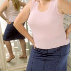 obese woman trying to close the buttons of her jeans