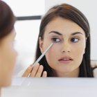 Asian woman applying makeup