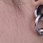 Young woman with nose studs and wearing studded ring, extreme close-up