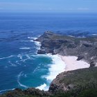 Wave crashing on rocky shoreline, Hawaii, USA