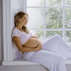 Pregnant African woman arranging flowers