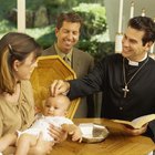 holding baby hand during christening