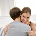 Woman lifting shirt and touching stomach