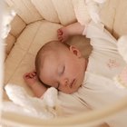 Smiling baby girl lying on a bed