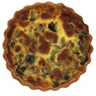 Asparagus quiche on white wooden surface